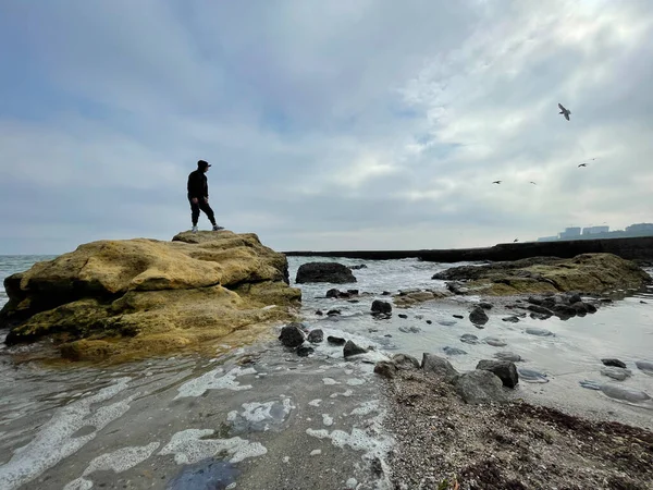 Silueta Muže Stojícího Skále Pláži Pod Dramatickou Oblohou — Stock fotografie