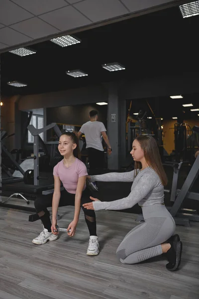Vertical Full Length Shot Teenage Girl Doing Squats Weights Her — Zdjęcie stockowe