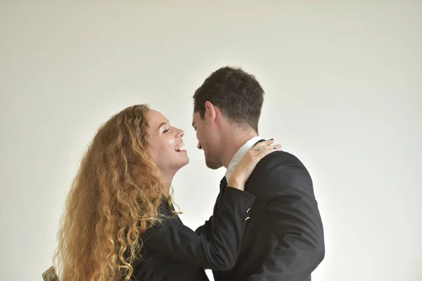 Woman and man in formal wear hugging, affair on workplace.