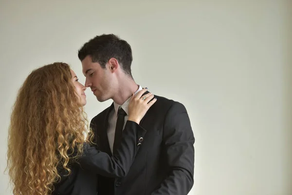 Woman and man in formal wear hugging, affair on workplace.