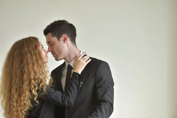 Woman and man in formal wear hugging, affair on workplace.