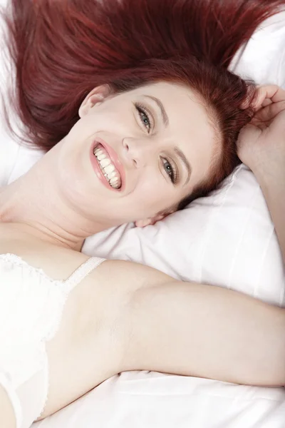 Woman in underwear lying on bed — Stock Photo, Image