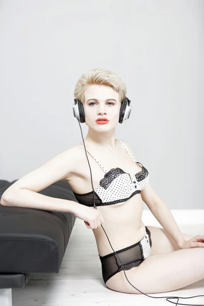Woman in underwear with headphones — Stock Photo, Image