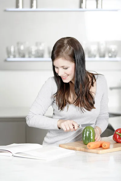 Woman reading cookery book — Stock Photo, Image