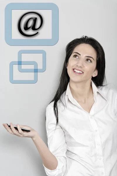 Woman holding out her phone displaying an email sign — Stock Photo, Image