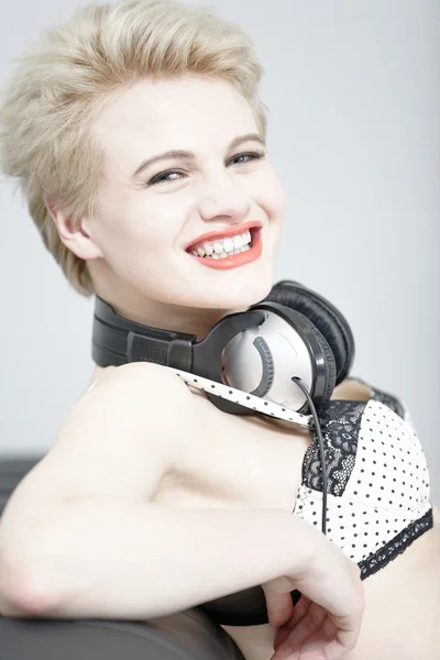 Woman in underwear with headphones — Stock Photo, Image
