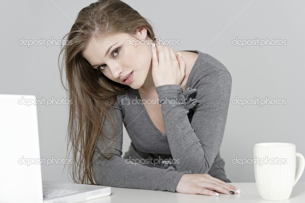 Woman at her desk in pain