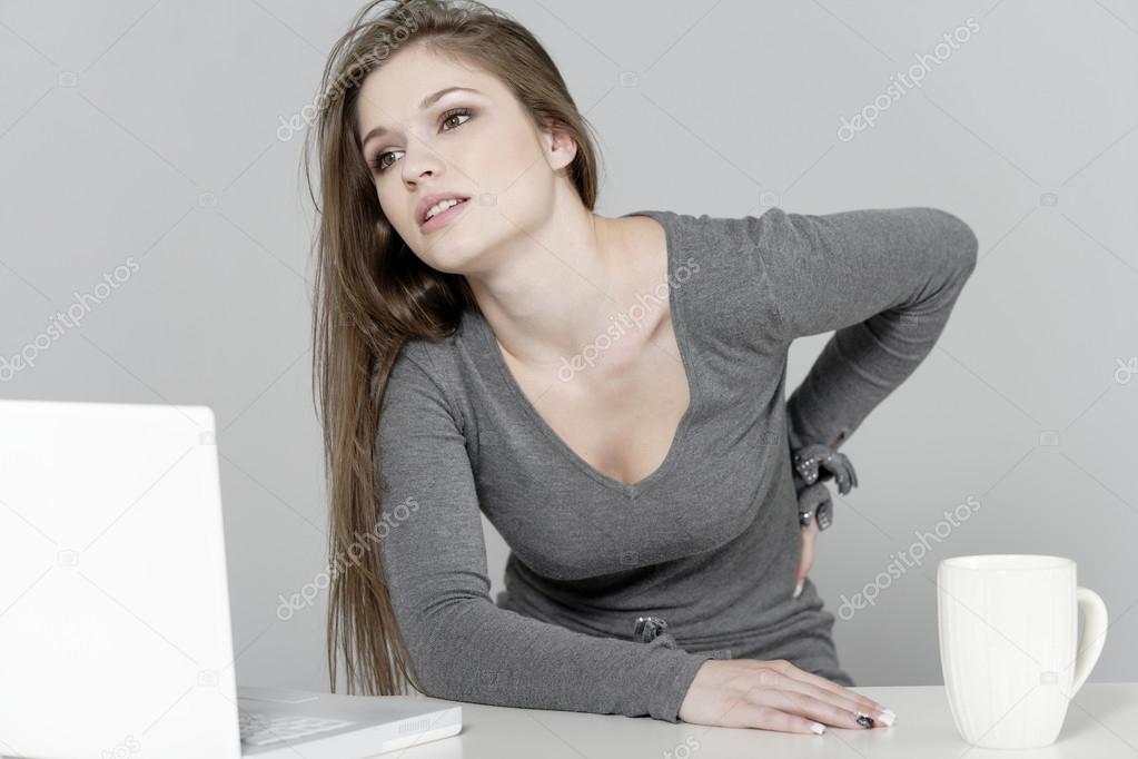 Woman at her desk in pain
