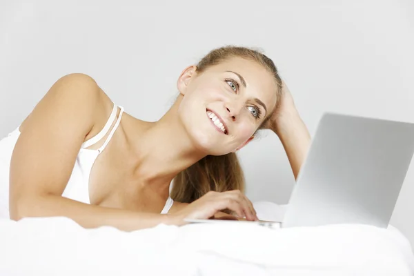 Woman working from her bed — Stock Photo, Image