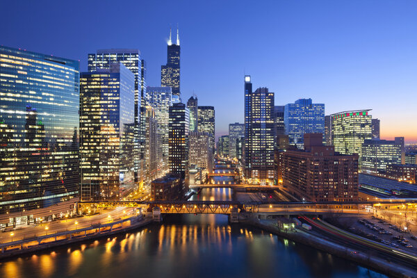 Image of Chicago downtown and Chicago River with bridges during sunset.