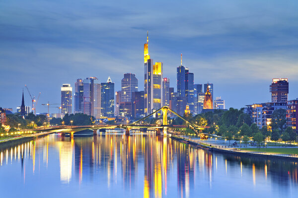 Image of Frankfurt am Main skyline after sunset with the reflection of the city in Main River.