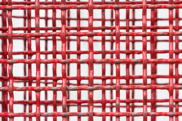 Hintergrund aus rotem Stahlgitter — Stockfoto