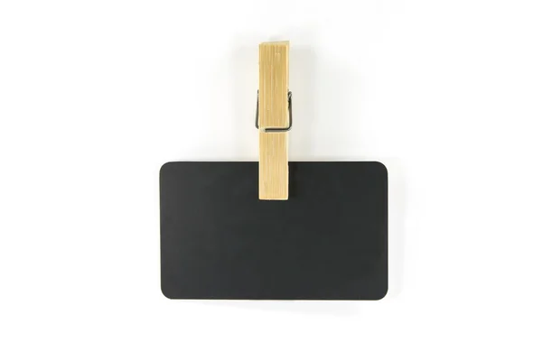 Wooden cloth pin with black card — Stock Photo, Image