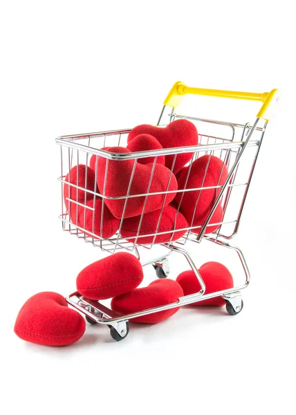 Many red hearts in shopping cart and fall on the floor — Stock Photo, Image