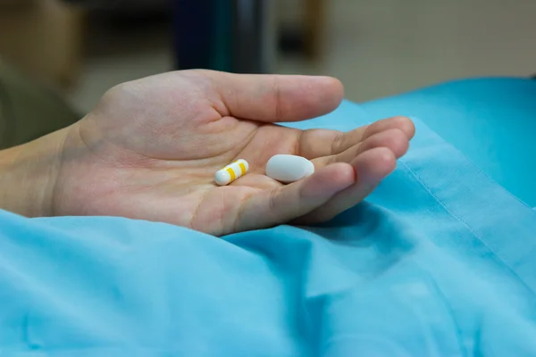 Closeup the pill in hand of patient — Stock Photo, Image