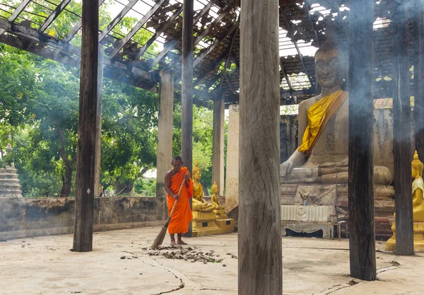 Mnich zamiatanie liść w dawnej kaplicy — Zdjęcie stockowe