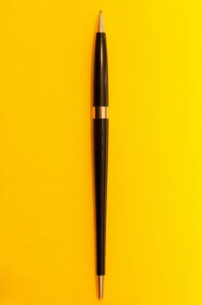 Full lenght luxury pen on yellow background — Stock Photo, Image
