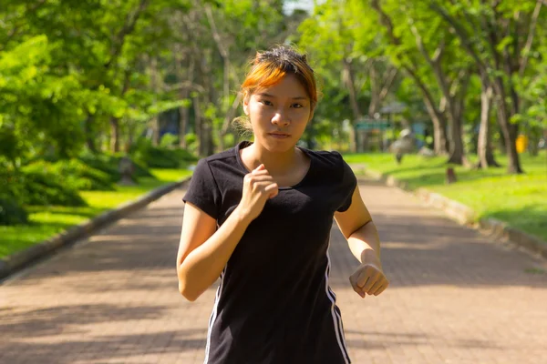 Young women with concentrated exercise by jogging — Stock Photo, Image