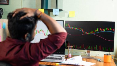 Monitor 'a odaklan, genç adam ana ofiste Graph on Computers izlerken başarısız ticaret stratejisinden dolayı hayal kırıklığına uğradı - hisse senetlerine yatırım yapma, borsa ve finans piyasasını analiz etme konsepti
