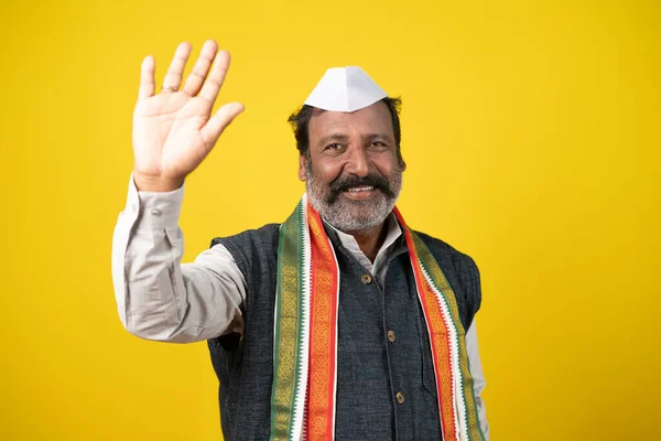 Senior Indan Politician Greeting Waving Hand Yellow Studio Background Concept — Stockfoto
