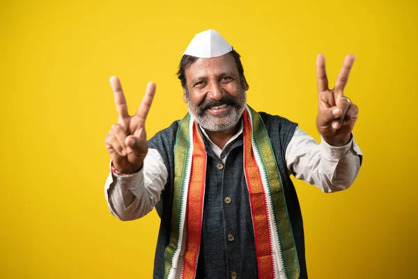 Happy smiling Politician showing victory or v sign gesture to audience - concept of Poll victory, positive or confidence about election results and win or successful celebration. — Stockfoto