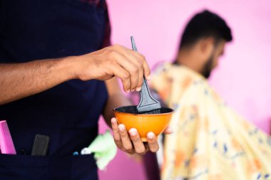 Fırçaya odaklan, kuaförü yakından çek kuaförde saç boyası ya da saç bakım malzemesi hazırla - beyaz saç problemi, saç bakımı ya da boya servisi için tedavi konsepti.