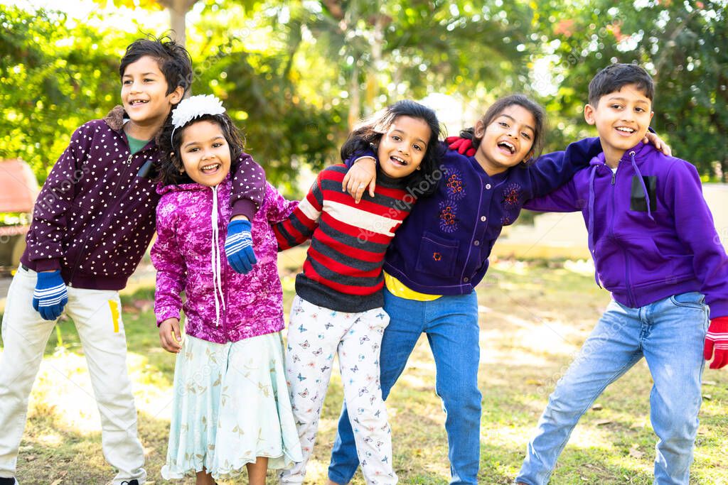 indian teenager kids enjoying or spending time with friends by dancing at park - concept of celebration, picnic, winter vacation and leisure activitys.