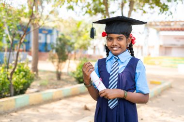Okul mezuniyet sertifikasını elinde tutarken mezuniyet hayalleri kuran üniformalı mutlu kız - gelecek kariyer, eğitim ve gelişme kavramı.