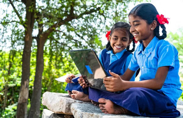 Handheld shot of Village school girl kids seriously busy working on laptop - concept of education, technology and knowledge — Stock Photo, Image