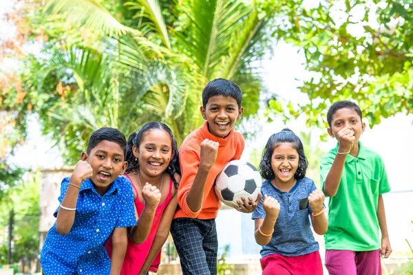 Group of teenager kids with football shouting by looking at camera - conecept of excitement, entertainment and competition — Stock Photo, Image