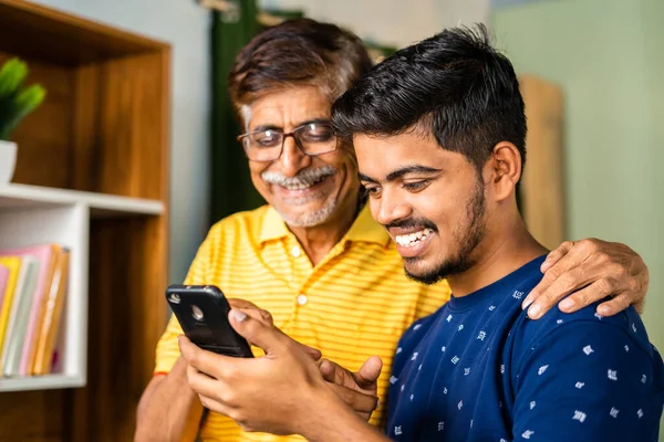 Happy Smiling Grandson Showing New Application Mobile Phone Grandfather Home — Photo