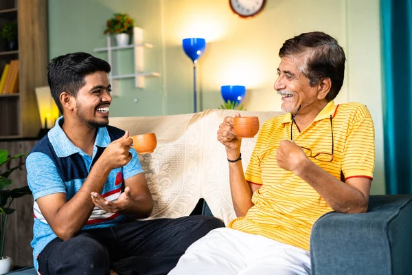 Happy Smiling Father Son Drinking Tea While Having Chat Home — 图库照片