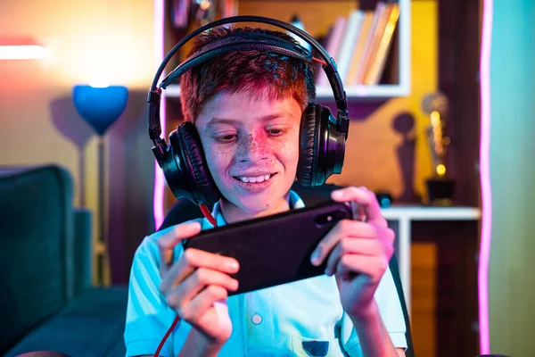 Happy Teenager Kid Headset Playing Video Game Mobile Phone Home — Fotografia de Stock