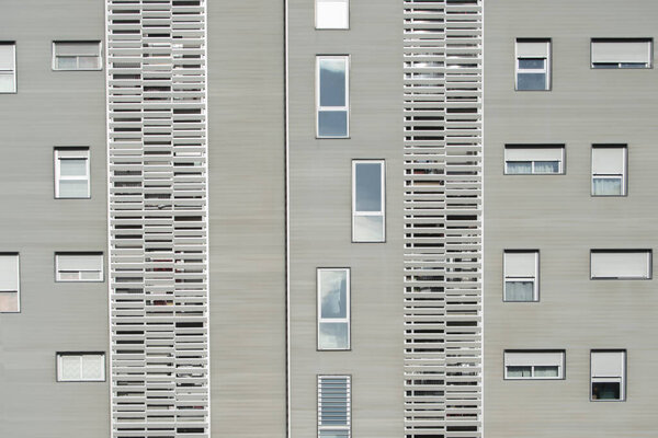 Modern building facade with rectangular windows in horizontal and vertical