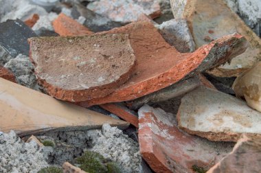 Yanmış çatıdan kırılmış terracotta fayansları. Kırık çatı kiremitleri, kil kırmızı kiremitler.