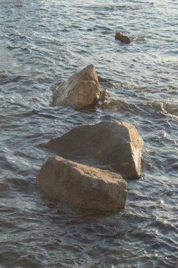 Several rocks in the mediterranean sea on the coast of Barcelona. Spain