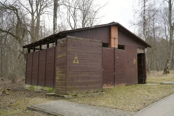 Old-fashioned USSR toilet architectural design sample in a landscaped Vintage environment in outdoors. A wooden board construction. Welcome back to the Soviet Union in Russia.