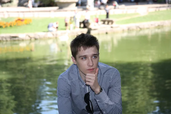 Young man in the autumn park — Stock Photo, Image