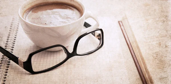 Artwork in vintage style, textbook, glasses and cup of coffee — Stock Photo, Image