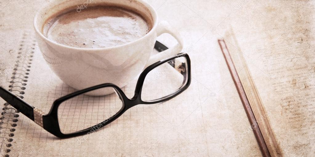 artwork in vintage style, textbook, glasses and cup of coffee