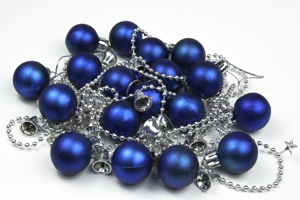 Blue christmas baubles with silver chain isolated on white — Stock Photo, Image