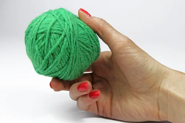 Woman hand with green ball of yarn for knitting isolated on whit — Stock Photo, Image