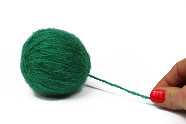 Woman hand with green ball of yarn for knitting — Stock Photo, Image