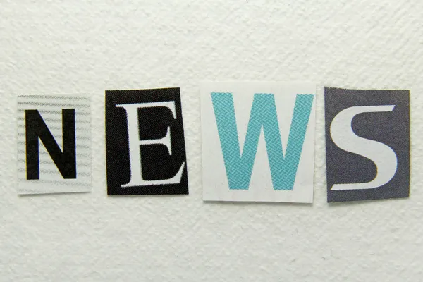news word cut from newspaper on handmade paper background