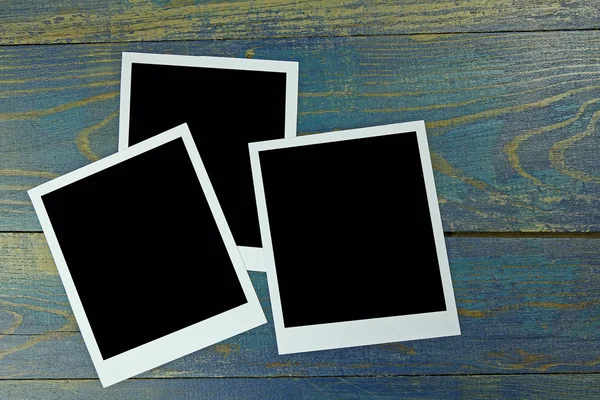 Three photo frame on old wooden background — Stock Photo, Image