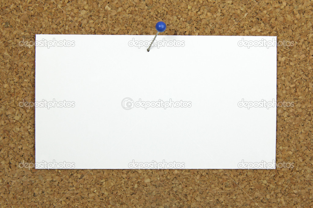 Push pin holding a blank notecard on a cork board