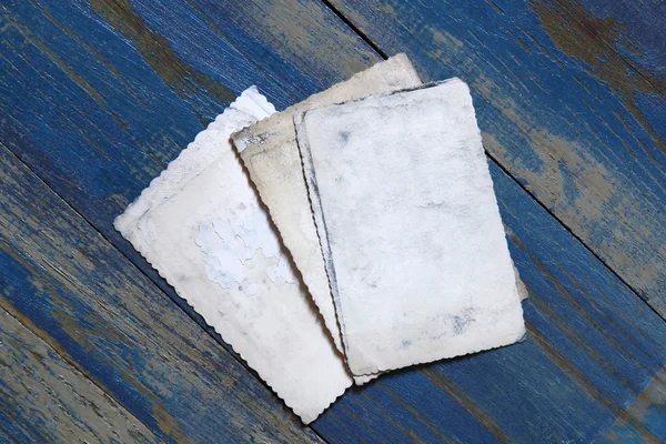 Old photo frames on blue wooden desk — Stock Photo, Image