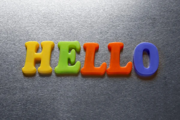 Hello word spelled out using colored fridge magnets — Stock Photo, Image