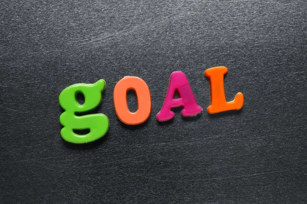Word goal spelled out using colored fridge magnets — Stock Photo, Image