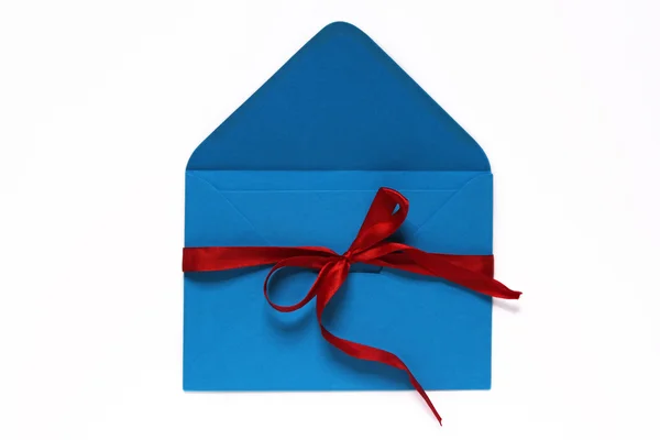 Open blue envelope tied with red ribbon and bow Royalty Free Stock Images